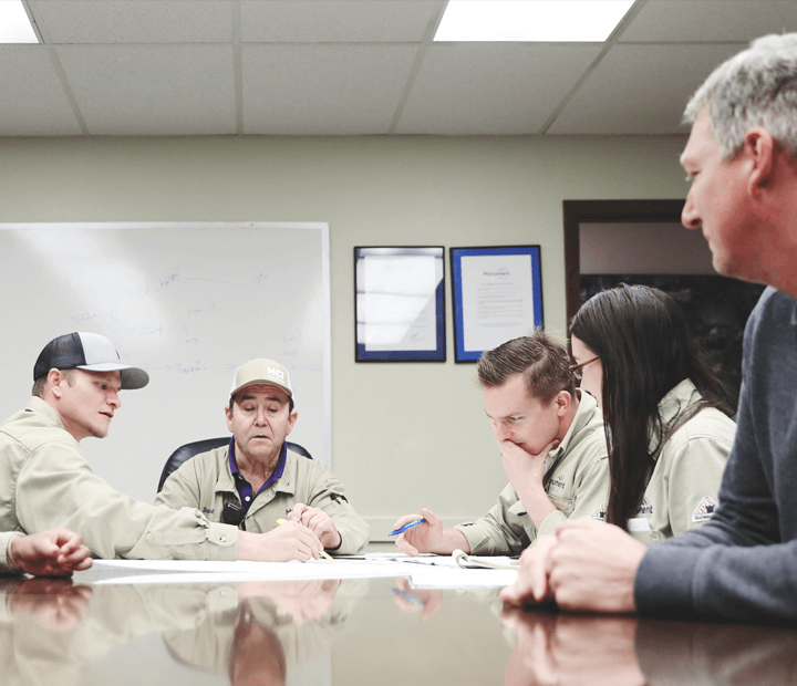 Employees around conference table